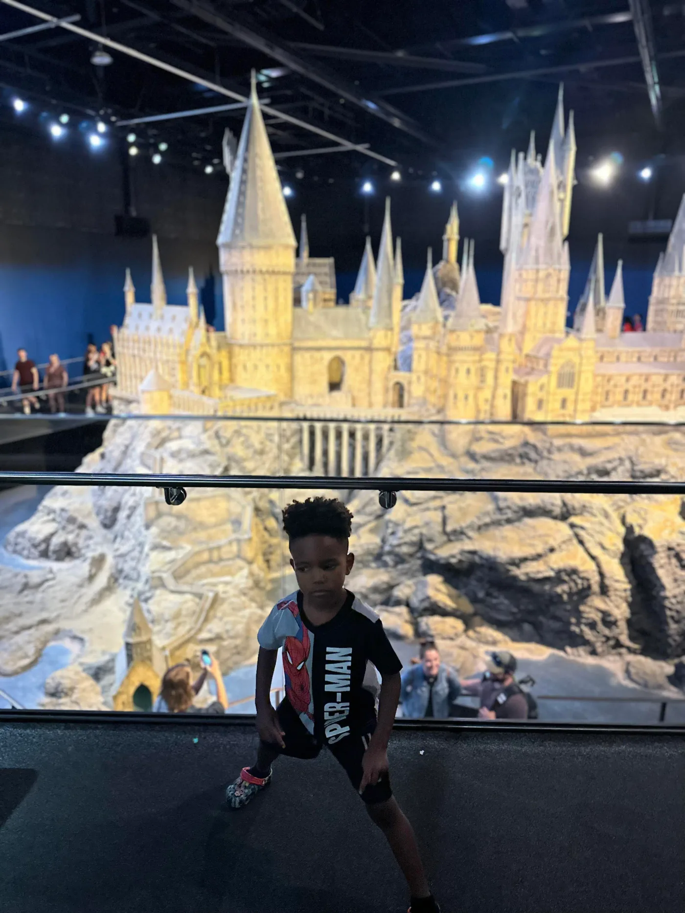 A detailed fantasy castle model in a studio display