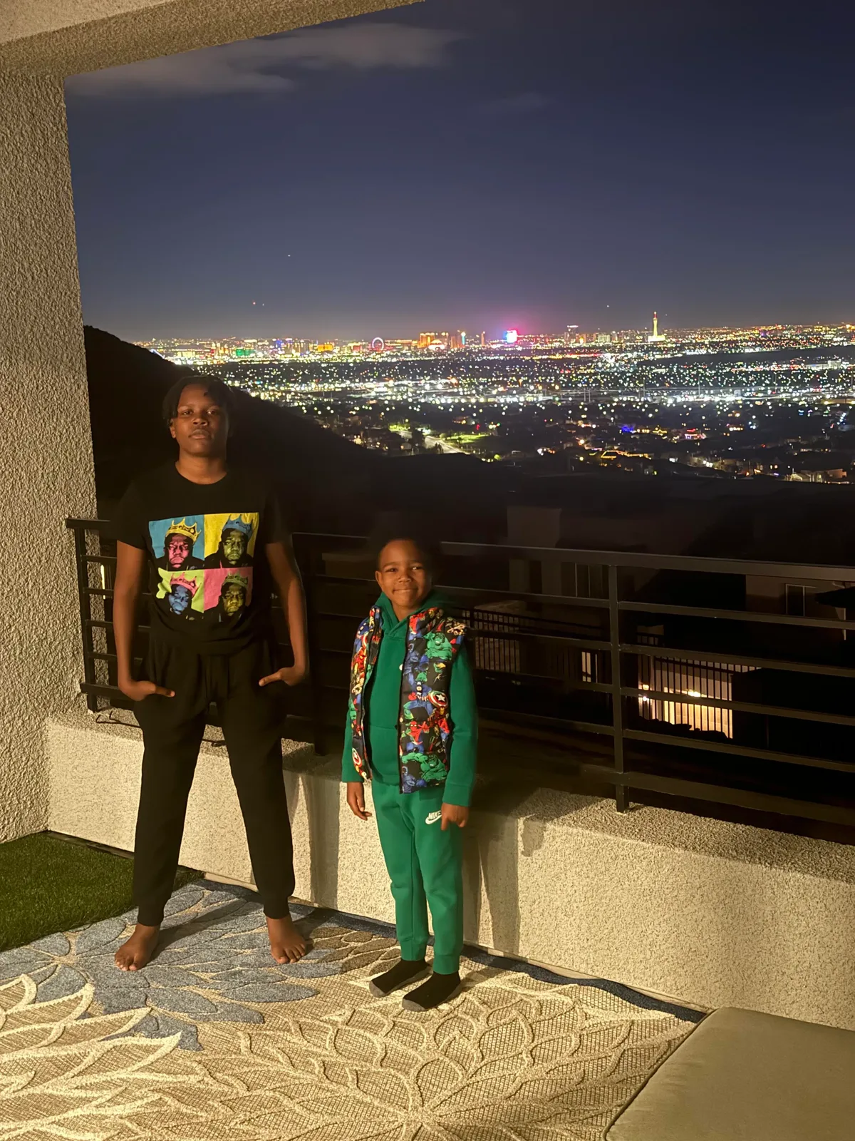 Two brothers with the Las Vegas skyline glowing behind them